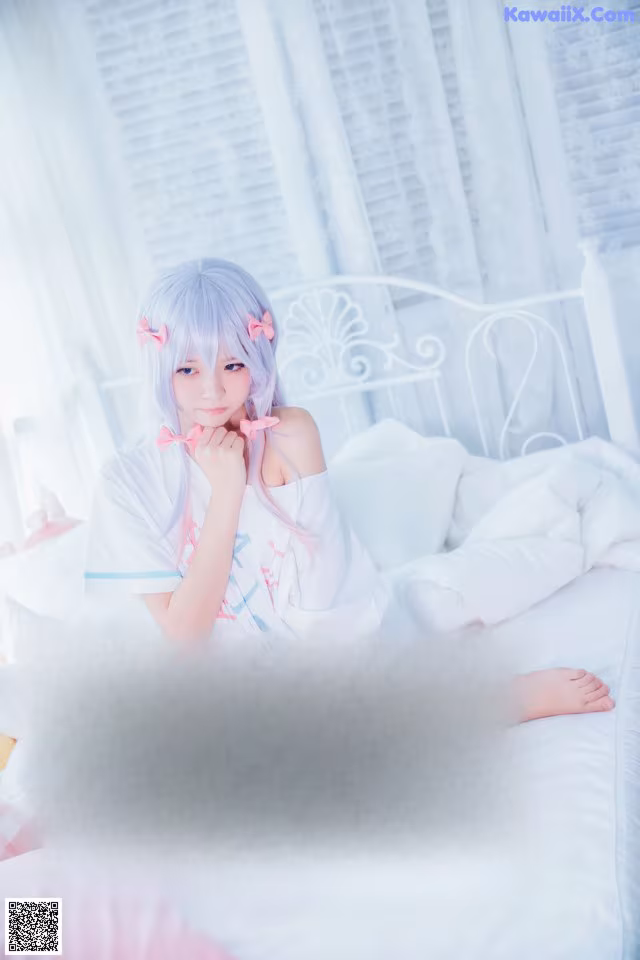 A woman sitting on top of a bed in a bedroom.