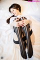 A woman laying on a bed with her legs crossed.