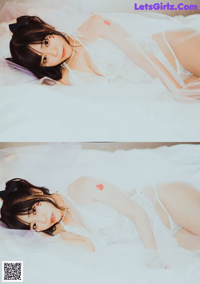 A woman laying on a bed in a white lingerie.