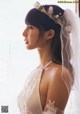 A woman in a wedding dress with a flower crown on her head.