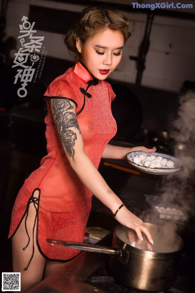 A woman in a red dress cooking food in a pot.