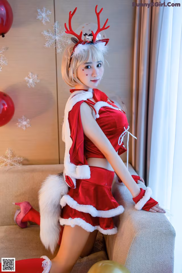 A woman dressed as a reindeer sitting on a couch.